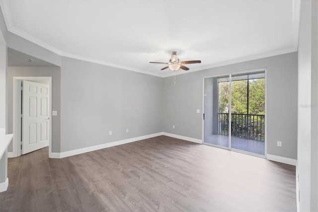 empty room with ceiling fan, wood finished floors, ornamental molding, and baseboards