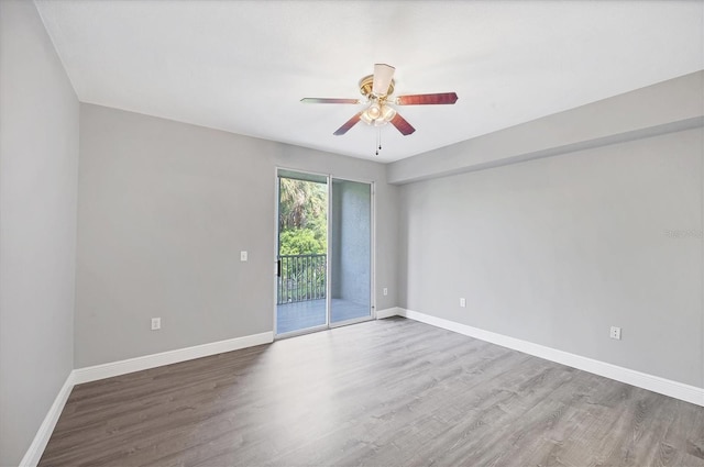 unfurnished room featuring ceiling fan, wood finished floors, and baseboards
