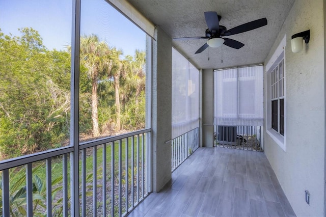 unfurnished sunroom featuring ceiling fan