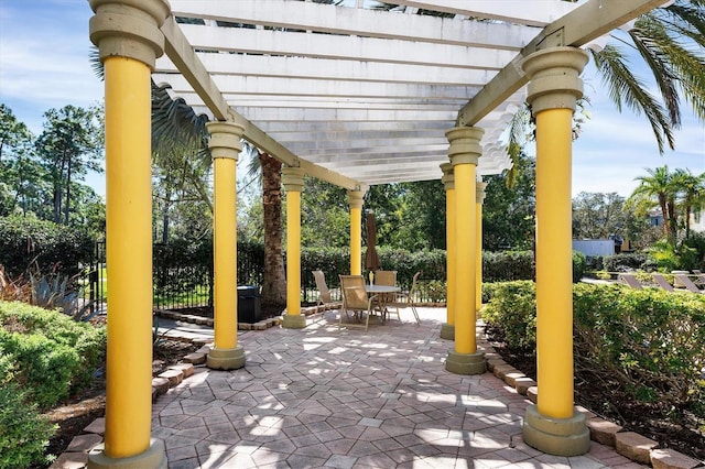 view of patio featuring a pergola, outdoor dining space, and fence