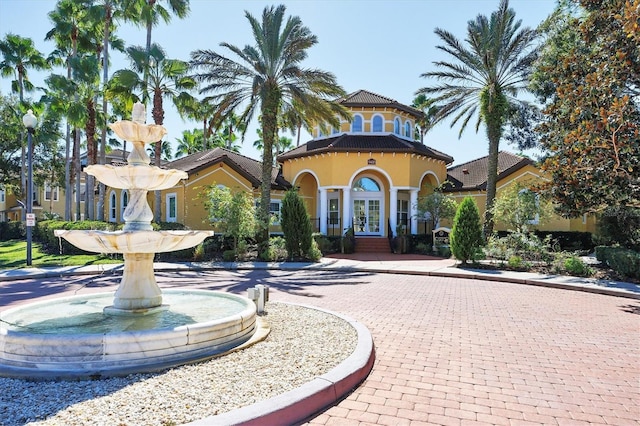 mediterranean / spanish home featuring french doors and stucco siding