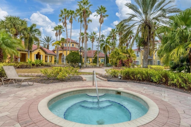 view of swimming pool featuring a community hot tub and a patio area
