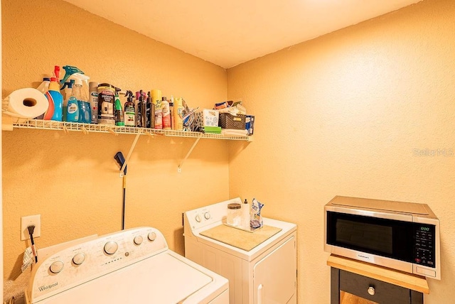 4061 Crockers Lake Blvd Unit 2618, Sarasota, FL 34238 - laundry area featuring independent washer and dryer, a textured wall, and laundry area