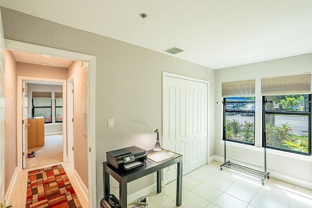 4061 Crockers Lake Blvd Unit 2618, Sarasota, FL 34238 - hallway featuring baseboards, visible vents, and light tile patterned flooring
