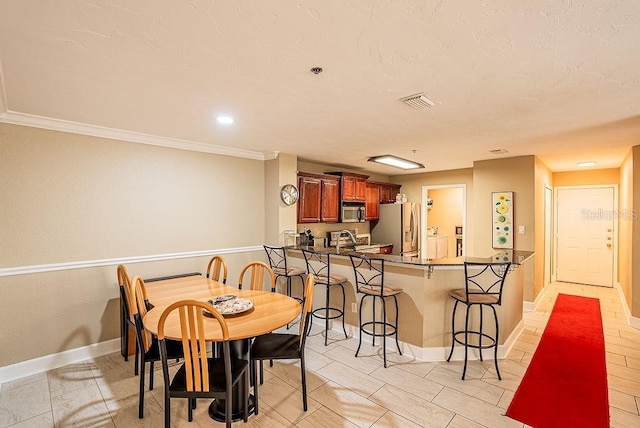 4061 Crockers Lake Blvd Unit 2618, Sarasota, FL 34238 - dining space featuring visible vents, baseboards, recessed lighting, and ornamental molding