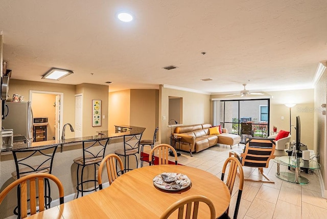 4061 Crockers Lake Blvd Unit 2618, Sarasota, FL 34238 - dining room featuring ornamental molding, a ceiling fan, and visible vents