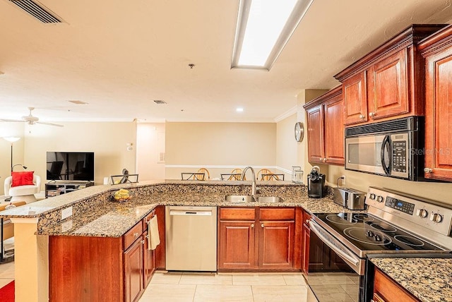 4061 Crockers Lake Blvd Unit 2618, Sarasota, FL 34238 - kitchen featuring stainless steel appliances, a sink, stone counters, visible vents, and ornamental molding