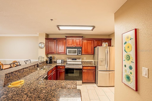 4061 Crockers Lake Blvd Unit 2618, Sarasota, FL 34238 - kitchen featuring dark stone countertops, a sink, a textured wall, a peninsula, and appliances with stainless steel finishes