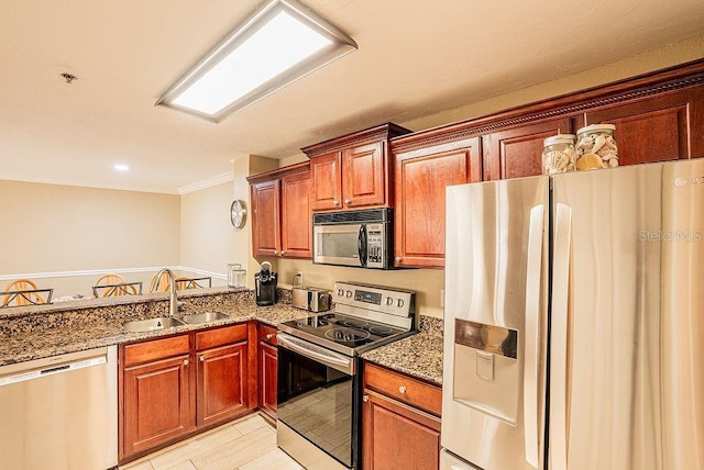 4061 Crockers Lake Blvd Unit 2618, Sarasota, FL 34238 - kitchen with stainless steel appliances, a sink, dark stone counters, brown cabinets, and ornamental molding