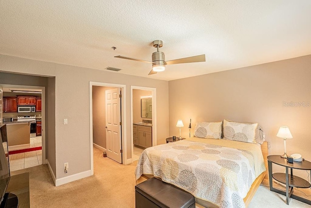 4061 Crockers Lake Blvd Unit 2618, Sarasota, FL 34238 - bedroom featuring connected bathroom, ceiling fan, light colored carpet, baseboards, and visible vents