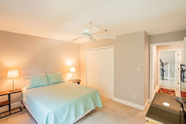 4061 Crockers Lake Blvd Unit 2618, Sarasota, FL 34238 - bedroom with light colored carpet, ceiling fan, baseboards, and a closet