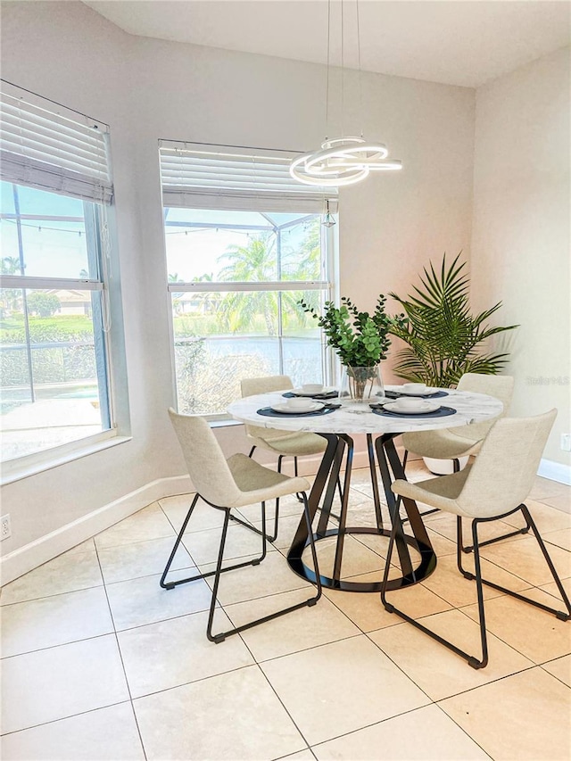 2980 Seasons Blvd, Sarasota, FL 34240 - dining area featuring baseboards, light tile patterned floors, and a chandelier