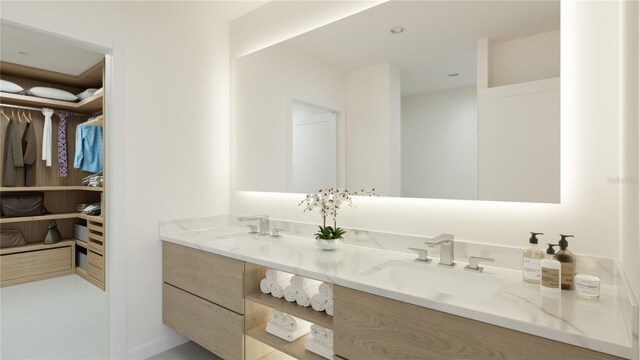 4950 Remington Dr Unit 304, Sarasota, FL 34234 - bathroom featuring double vanity, a spacious closet, and a sink
