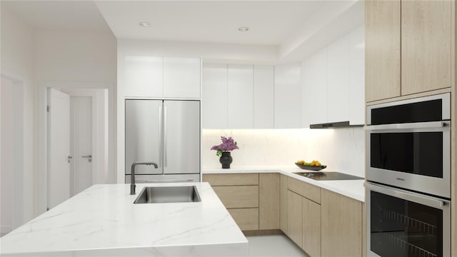 4950 Remington Dr Unit 304, Sarasota, FL 34234 - kitchen with modern cabinets, light stone counters, a sink, and appliances with stainless steel finishes