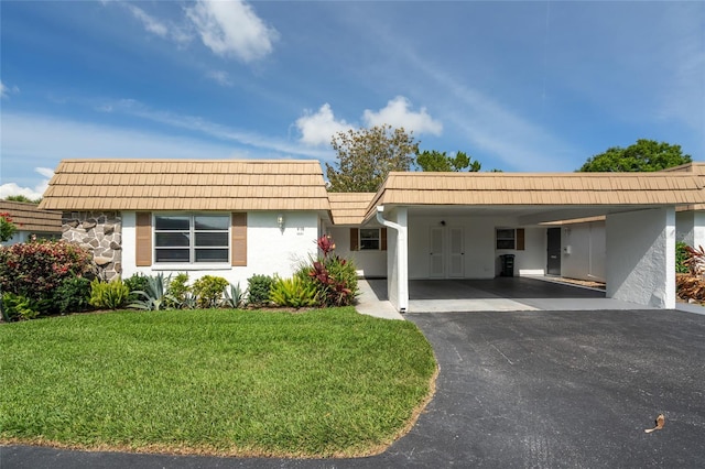 5521 Riverbluff Cir Unit V-10, Sarasota, FL 34231 - view of front of home featuring stucco siding, a front yard, mansard roof, and asphalt driveway