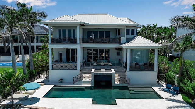 1435 Westway Dr, Sarasota, FL 34236 - back of house featuring a balcony, a ceiling fan, a standing seam roof, a metal roof, and stairway