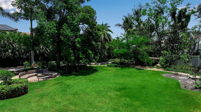 1435 Westway Dr, Sarasota, FL 34236 - view of grassy yard featuring an outdoor fire pit