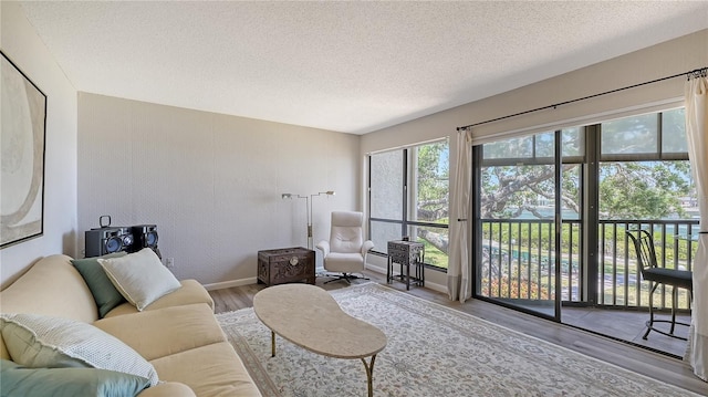 6157 Midnight Pass Rd Unit B42, Sarasota, FL 34242 - living area featuring baseboards, wood finished floors, and a textured ceiling