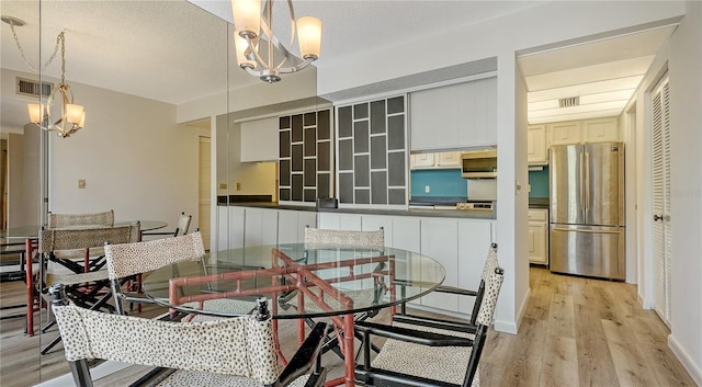 6157 Midnight Pass Rd Unit B42, Sarasota, FL 34242 - dining area with a chandelier, visible vents, and light wood-style floors