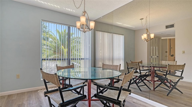 6157 Midnight Pass Rd Unit B42, Sarasota, FL 34242 - dining room with light wood finished floors, baseboards, visible vents, and an inviting chandelier