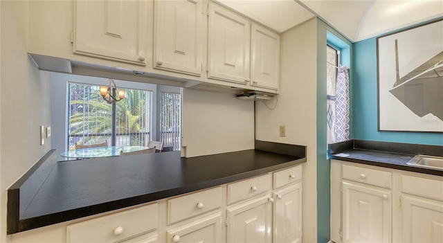 6157 Midnight Pass Rd Unit B42, Sarasota, FL 34242 - kitchen featuring white cabinets and dark countertops