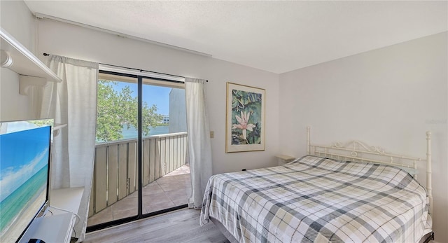 6157 Midnight Pass Rd Unit B42, Sarasota, FL 34242 - bedroom featuring wood finished floors, a water view, and access to exterior