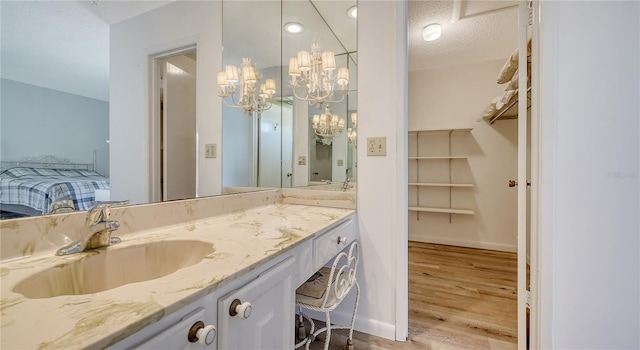 6157 Midnight Pass Rd Unit B42, Sarasota, FL 34242 - bathroom with baseboards, wood finished floors, vanity, and an inviting chandelier