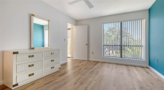 6157 Midnight Pass Rd Unit B42, Sarasota, FL 34242 - unfurnished bedroom featuring light wood-style flooring, baseboards, and multiple windows