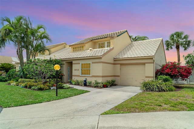 3609 57th Avenue Dr W Unit 37, Bradenton, FL 34210 - view of front of property with an attached garage, driveway, stucco siding, a lawn, and a tile roof
