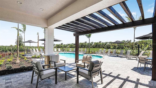 8596 Lunar Skye St, Sarasota, FL 34241 - view of patio / terrace featuring fence, a pergola, and a community pool