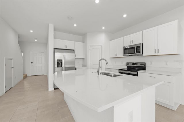 8596 Lunar Skye St, Sarasota, FL 34241 - kitchen featuring white cabinets, a sink, an island with sink, and appliances with stainless steel finishes
