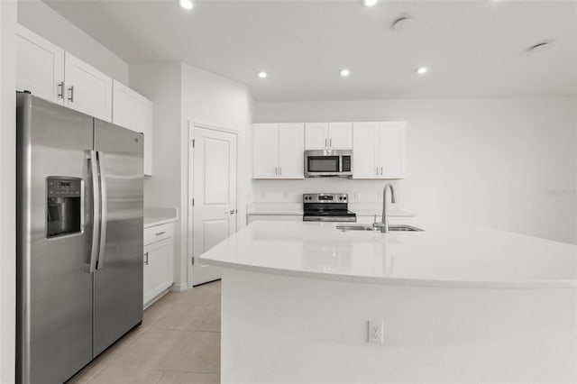 8596 Lunar Skye St, Sarasota, FL 34241 - kitchen featuring stainless steel appliances, a sink, white cabinetry, light countertops, and light tile patterned floors