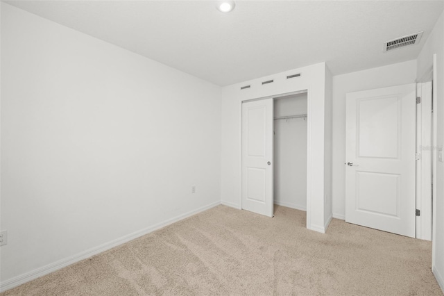 8596 Lunar Skye St, Sarasota, FL 34241 - unfurnished bedroom with baseboards, visible vents, carpet, and a closet