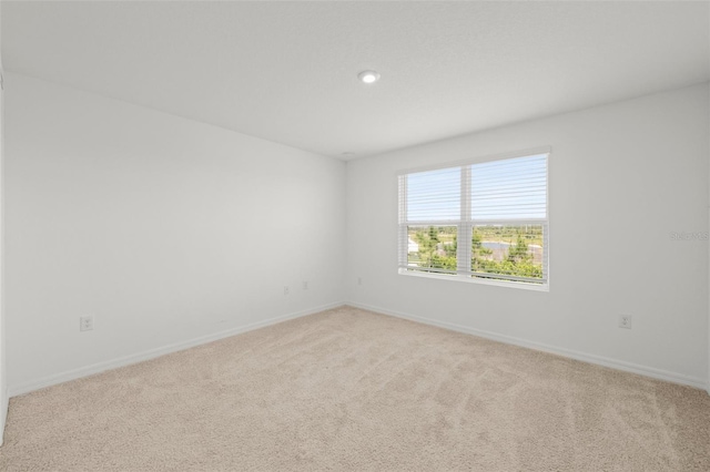 8596 Lunar Skye St, Sarasota, FL 34241 - empty room with baseboards, recessed lighting, and light colored carpet