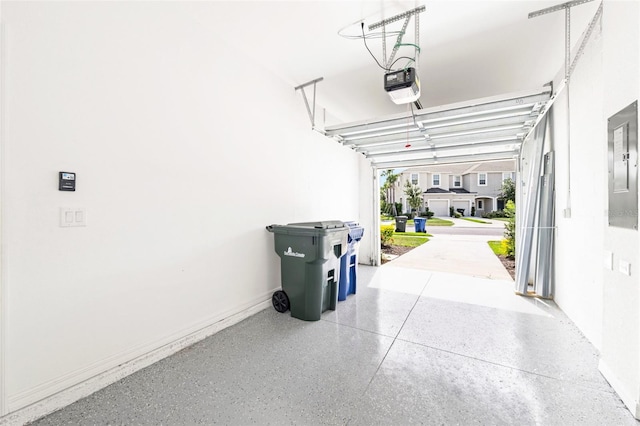 8596 Lunar Skye St, Sarasota, FL 34241 - garage with electric panel, baseboards, and a garage door opener