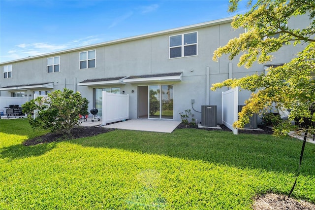 8596 Lunar Skye St, Sarasota, FL 34241 - rear view of property with a yard, central air condition unit, a patio, and stucco siding