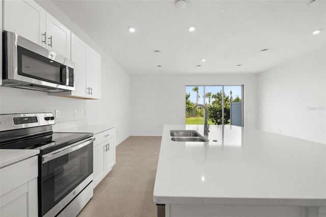 8596 Lunar Skye St, Sarasota, FL 34241 - kitchen featuring a sink, stainless steel appliances, a center island with sink, light countertops, and recessed lighting