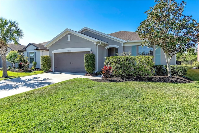10806 52nd Ct E, Parrish, FL 34219 - ranch-style home with stucco siding, an attached garage, a front yard, and driveway