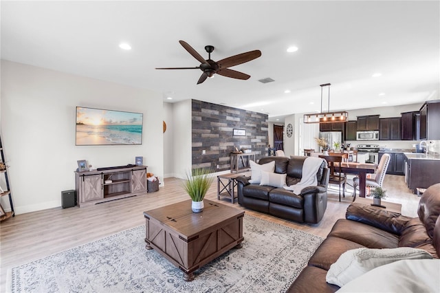 10806 52nd Ct E, Parrish, FL 34219 - living room featuring a ceiling fan, recessed lighting, and light wood-type flooring