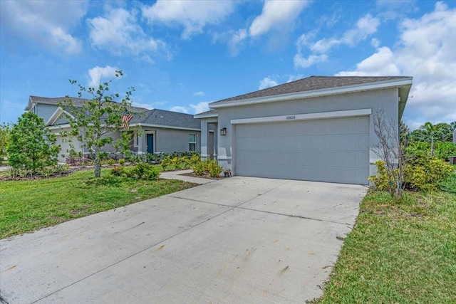 10616 High Noon Trl, Parrish, FL 34219 - single story home featuring an attached garage, driveway, a front yard, and stucco siding
