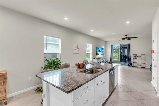 10616 High Noon Trl, Parrish, FL 34219 - kitchen featuring stainless steel dishwasher, a sink, dark stone countertops, and a healthy amount of sunlight