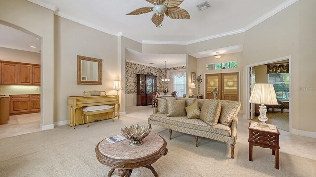 5355 Anthony Ln, Sarasota, FL 34233 - living area featuring arched walkways, healthy amount of natural light, a ceiling fan, baseboards, and ornamental molding