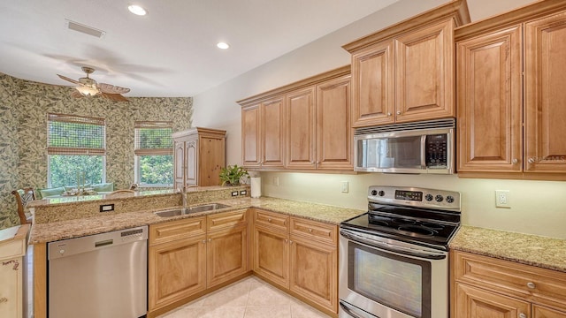 5355 Anthony Ln, Sarasota, FL 34233 - kitchen with appliances with stainless steel finishes, a sink, ceiling fan, light stone countertops, and a peninsula