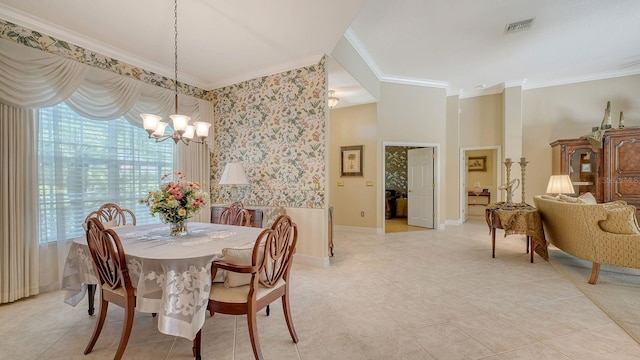 5355 Anthony Ln, Sarasota, FL 34233 - dining space with a chandelier, ornamental molding, healthy amount of natural light, light tile patterned floors, and baseboards