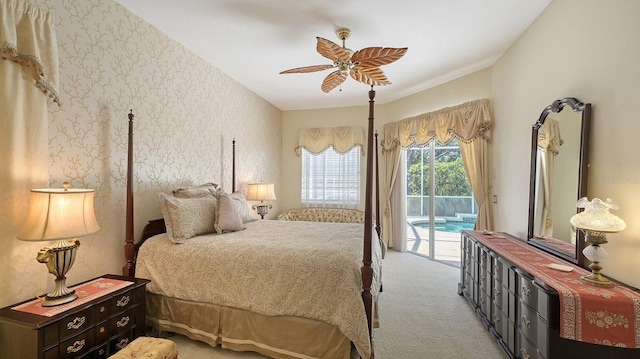 5355 Anthony Ln, Sarasota, FL 34233 - carpeted bedroom featuring access to exterior, wallpapered walls, and ceiling fan