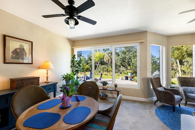 2397 Vaccaro Dr, Sarasota, FL 34231 - dining room featuring ceiling fan, a textured wall, and baseboards