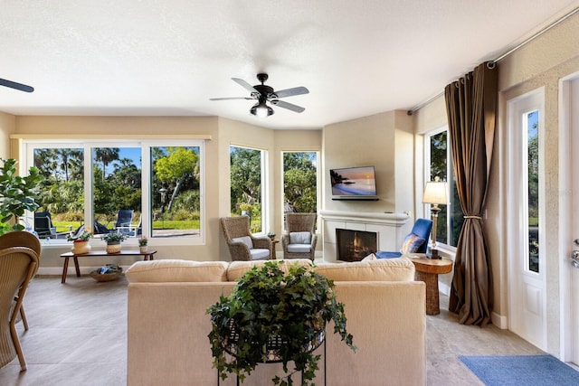 2397 Vaccaro Dr, Sarasota, FL 34231 - living room with a ceiling fan, a large fireplace, and light tile patterned flooring