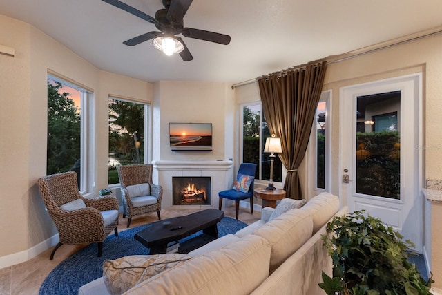2397 Vaccaro Dr, Sarasota, FL 34231 - living area with a ceiling fan, a lit fireplace, plenty of natural light, and baseboards