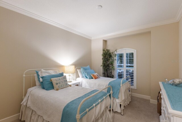 2397 Vaccaro Dr, Sarasota, FL 34231 - bedroom with crown molding, baseboards, and light carpet