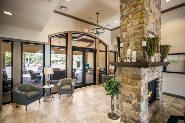 2397 Vaccaro Dr, Sarasota, FL 34231 - living area with ornamental molding, recessed lighting, french doors, a stone fireplace, and baseboards